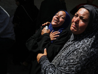 Palestinian women are mourning the death of loved ones following Israeli bombardment, outside a hospital in Deir el-Balah in the central Gaz...