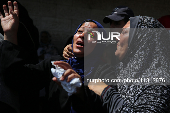 Palestinian women are mourning the death of loved ones following Israeli bombardment, outside a hospital in Deir el-Balah in the central Gaz...