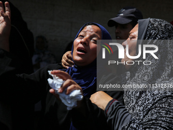 Palestinian women are mourning the death of loved ones following Israeli bombardment, outside a hospital in Deir el-Balah in the central Gaz...