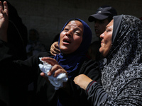 Palestinian women are mourning the death of loved ones following Israeli bombardment, outside a hospital in Deir el-Balah in the central Gaz...