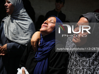 Palestinian women are mourning the death of loved ones following Israeli bombardment, outside a hospital in Deir el-Balah in the central Gaz...