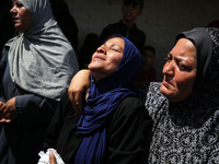 Palestinian women are mourning the death of loved ones following Israeli bombardment, outside a hospital in Deir el-Balah in the central Gaz...