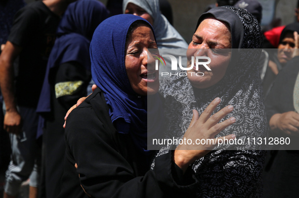 Palestinian women are mourning the death of loved ones following Israeli bombardment, outside a hospital in Deir el-Balah in the central Gaz...