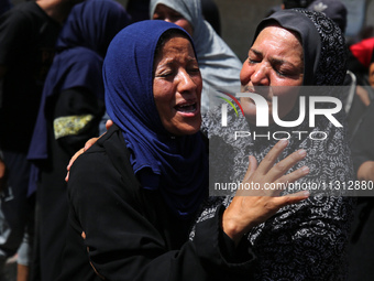 Palestinian women are mourning the death of loved ones following Israeli bombardment, outside a hospital in Deir el-Balah in the central Gaz...