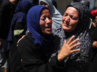 Palestinian women are mourning the death of loved ones following Israeli bombardment, outside a hospital in Deir el-Balah in the central Gaz...