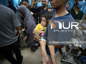 Palestinians are rushing a person into Al-Aqsa Martyrs Hospital in Deir el-Balah in the central Gaza Strip following Israeli bombardment. In...