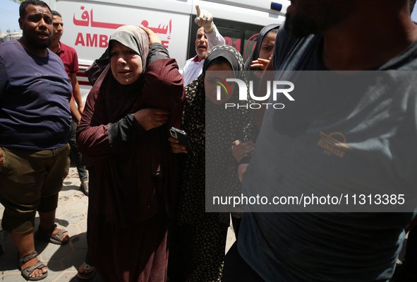 Palestinians are rushing a person into Al-Aqsa Martyrs Hospital in Deir el-Balah in the central Gaza Strip following Israeli bombardment. In...