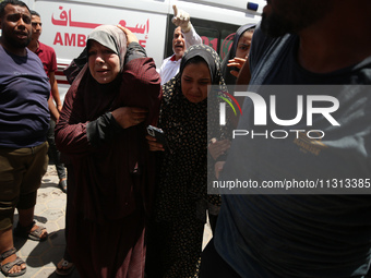 Palestinians are rushing a person into Al-Aqsa Martyrs Hospital in Deir el-Balah in the central Gaza Strip following Israeli bombardment. In...