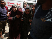 Palestinians are rushing a person into Al-Aqsa Martyrs Hospital in Deir el-Balah in the central Gaza Strip following Israeli bombardment. In...