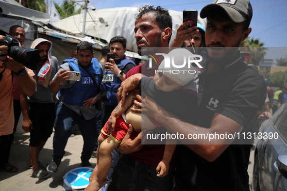 Palestinians are rushing a person into Al-Aqsa Martyrs Hospital in Deir el-Balah in the central Gaza Strip following Israeli bombardment. In...