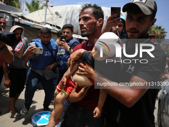 Palestinians are rushing a person into Al-Aqsa Martyrs Hospital in Deir el-Balah in the central Gaza Strip following Israeli bombardment. In...