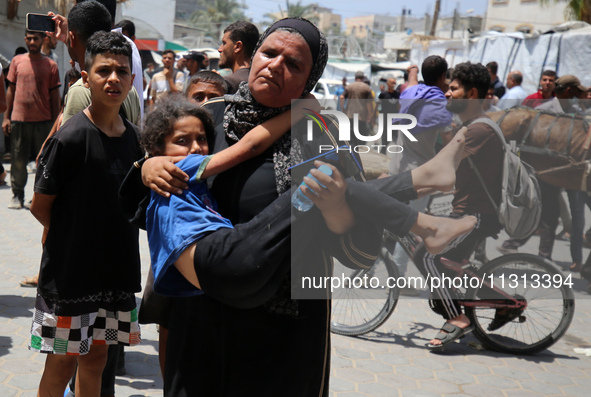 Palestinians are rushing a person into Al-Aqsa Martyrs Hospital in Deir el-Balah in the central Gaza Strip following Israeli bombardment. In...