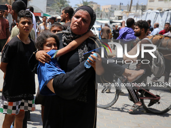 Palestinians are rushing a person into Al-Aqsa Martyrs Hospital in Deir el-Balah in the central Gaza Strip following Israeli bombardment. In...