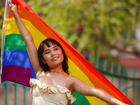 A participant is displaying a pride flag while taking part in the annual Nepal Pride Parade in Kathmandu, Nepal, on June 8, 2024. Hundreds o...