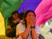 A participant is reacting while sitting under the seven-colored pride flag during the annual Pride Parade in Kathmandu, Nepal, on June 8, 20...