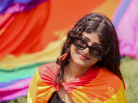 A participant is draped in a pride flag and posing for a photo while attending the annual Pride Parade in Kathmandu, Nepal, on June 8, 2024....