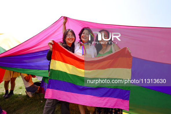 Participants are displaying the pride flag while taking part in the annual Nepal Pride Parade in Kathmandu, Nepal, on June 8, 2024. Hundreds...