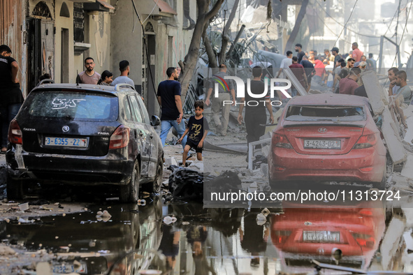 Palestinians are walking on the rubble of destroyed buildings following operations by the Israeli Special Forces in the Nuseirat camp, in th...