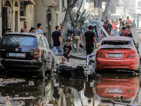 Palestinians are walking on the rubble of destroyed buildings following operations by the Israeli Special Forces in the Nuseirat camp, in th...