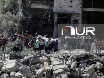 Palestinians are walking on the rubble of destroyed buildings following operations by the Israeli Special Forces in the Nuseirat camp, in th...