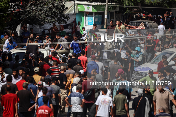 Mourners are reacting during the funeral of Palestinians killed in Israeli strikes, amid the Israel-Hamas conflict, in Deir Al-Balah, in cen...