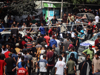 Mourners are reacting during the funeral of Palestinians killed in Israeli strikes, amid the Israel-Hamas conflict, in Deir Al-Balah, in cen...