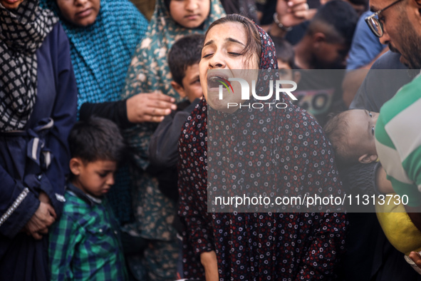 A mourner is reacting during the funeral of Palestinians killed in Israeli strikes, amid the Israel-Hamas conflict, in Deir Al-Balah, in cen...