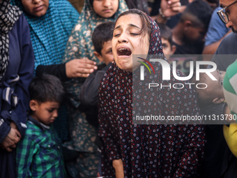 A mourner is reacting during the funeral of Palestinians killed in Israeli strikes, amid the Israel-Hamas conflict, in Deir Al-Balah, in cen...