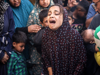 A mourner is reacting during the funeral of Palestinians killed in Israeli strikes, amid the Israel-Hamas conflict, in Deir Al-Balah, in cen...