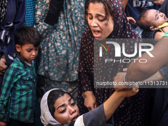 A mourner is reacting during the funeral of Palestinians killed in Israeli strikes, amid the Israel-Hamas conflict, in Deir Al-Balah, in cen...