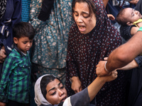 A mourner is reacting during the funeral of Palestinians killed in Israeli strikes, amid the Israel-Hamas conflict, in Deir Al-Balah, in cen...