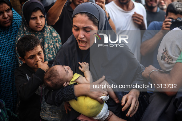 A mourner is reacting during the funeral of Palestinians killed in Israeli strikes, amid the Israel-Hamas conflict, in Deir Al-Balah, in cen...