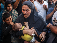 A mourner is reacting during the funeral of Palestinians killed in Israeli strikes, amid the Israel-Hamas conflict, in Deir Al-Balah, in cen...