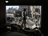 Palestinians are walking on the rubble of destroyed buildings following operations by the Israeli Special Forces in the Nuseirat camp, in th...