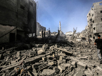 Palestinians are walking on the rubble of destroyed buildings following operations by the Israeli Special Forces in the Nuseirat camp, in th...