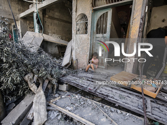 Palestinians are standing on the rubble of destroyed buildings following operations by the Israeli Special Forces in the Nuseirat camp, in t...