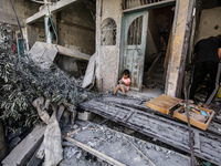 Palestinians are standing on the rubble of destroyed buildings following operations by the Israeli Special Forces in the Nuseirat camp, in t...