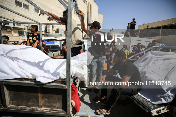 Mourners are reacting during the funeral of Palestinians killed in Israeli strikes, amid the Israel-Hamas conflict, in Deir Al-Balah, in cen...