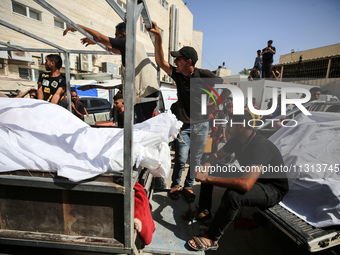 Mourners are reacting during the funeral of Palestinians killed in Israeli strikes, amid the Israel-Hamas conflict, in Deir Al-Balah, in cen...