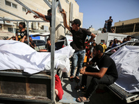 Mourners are reacting during the funeral of Palestinians killed in Israeli strikes, amid the Israel-Hamas conflict, in Deir Al-Balah, in cen...