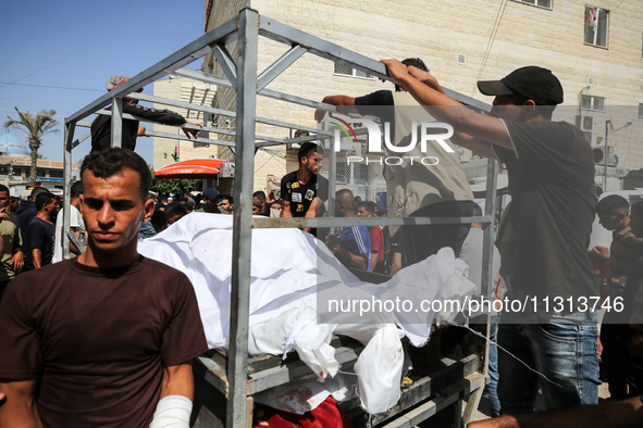 Mourners are reacting during the funeral of Palestinians killed in Israeli strikes, amid the Israel-Hamas conflict, in Deir Al-Balah, in cen...