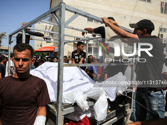 Mourners are reacting during the funeral of Palestinians killed in Israeli strikes, amid the Israel-Hamas conflict, in Deir Al-Balah, in cen...