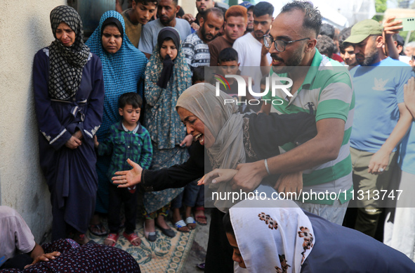 A mourner is reacting during the funeral of Palestinians killed in Israeli strikes, amid the Israel-Hamas conflict, in Deir Al-Balah, in cen...