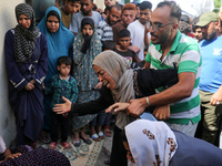 A mourner is reacting during the funeral of Palestinians killed in Israeli strikes, amid the Israel-Hamas conflict, in Deir Al-Balah, in cen...