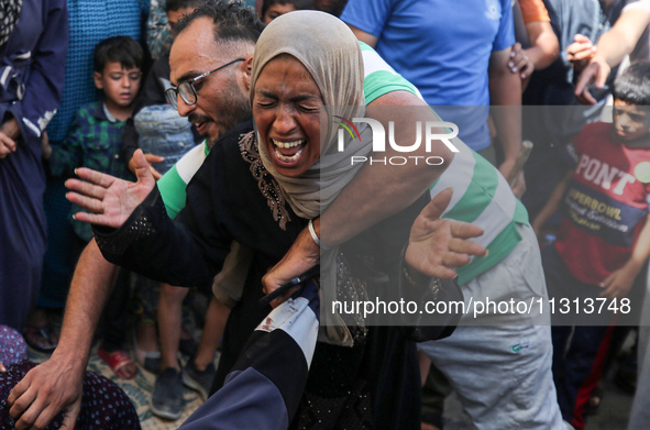 A mourner is reacting during the funeral of Palestinians killed in Israeli strikes, amid the Israel-Hamas conflict, in Deir Al-Balah, in cen...