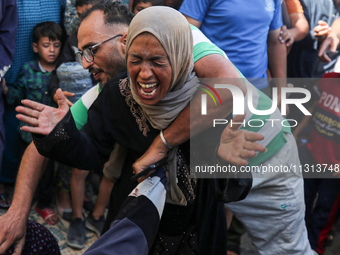 A mourner is reacting during the funeral of Palestinians killed in Israeli strikes, amid the Israel-Hamas conflict, in Deir Al-Balah, in cen...