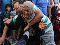 A mourner is reacting during the funeral of Palestinians killed in Israeli strikes, amid the Israel-Hamas conflict, in Deir Al-Balah, in cen...