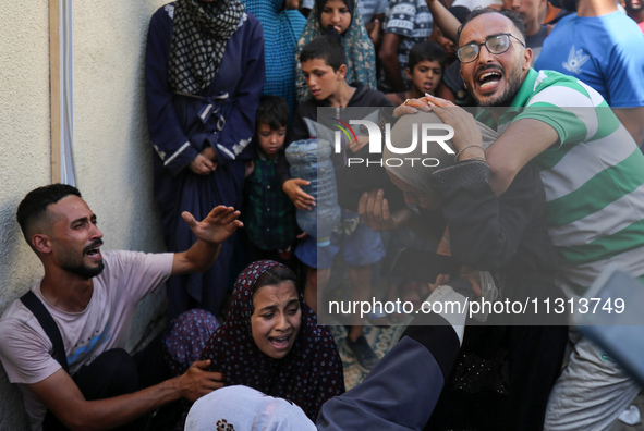 A mourner is reacting during the funeral of Palestinians killed in Israeli strikes, amid the Israel-Hamas conflict, in Deir Al-Balah, in cen...