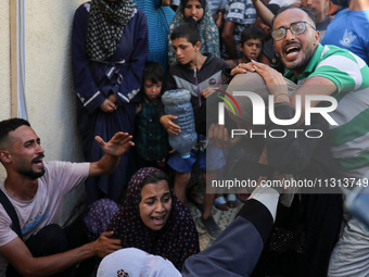 A mourner is reacting during the funeral of Palestinians killed in Israeli strikes, amid the Israel-Hamas conflict, in Deir Al-Balah, in cen...