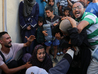 A mourner is reacting during the funeral of Palestinians killed in Israeli strikes, amid the Israel-Hamas conflict, in Deir Al-Balah, in cen...